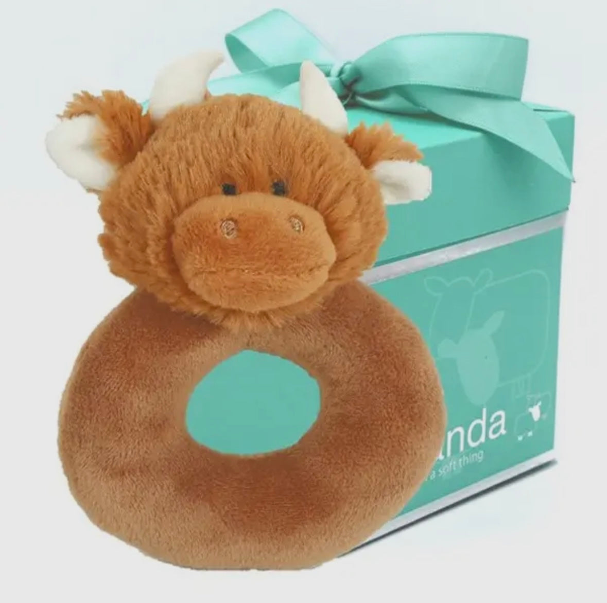 front view of the Scottish Highland Cow Baby Rattle displaying its charming design and packaging